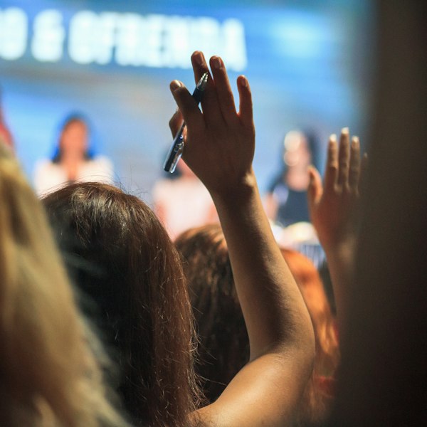 People at a meeting raising their hands to vote