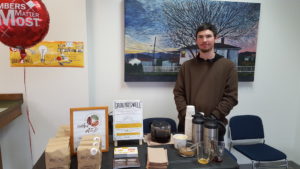 The Groundswell Grassroots Economic Alternatives table showing off their new small batch roasters venture.